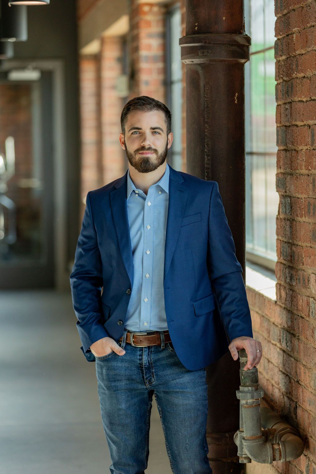 Travis McCullough standing in a brick-walled office